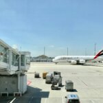 white Emirates airplane on airport